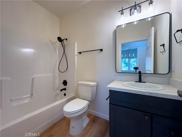 full bathroom featuring shower / bathing tub combination, vanity, hardwood / wood-style floors, and toilet