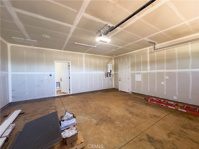 garage featuring a garage door opener and water heater