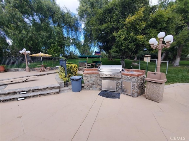 view of patio with area for grilling and exterior kitchen