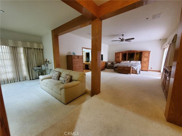 bedroom featuring beamed ceiling, light colored carpet, and ceiling fan