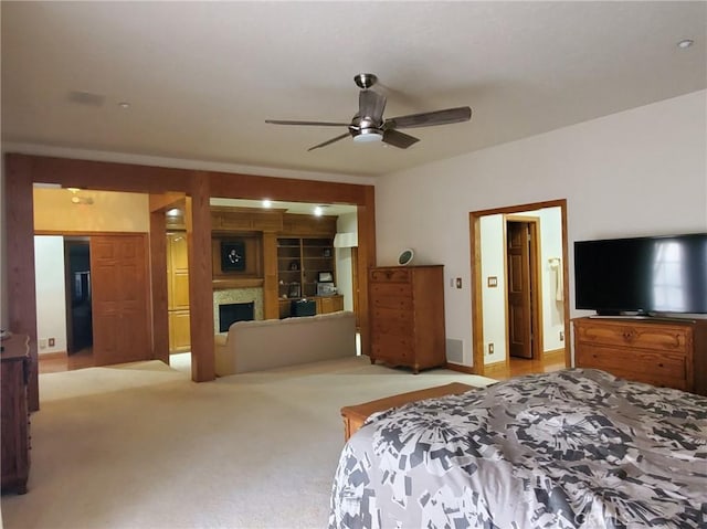 carpeted bedroom with ceiling fan and ensuite bathroom