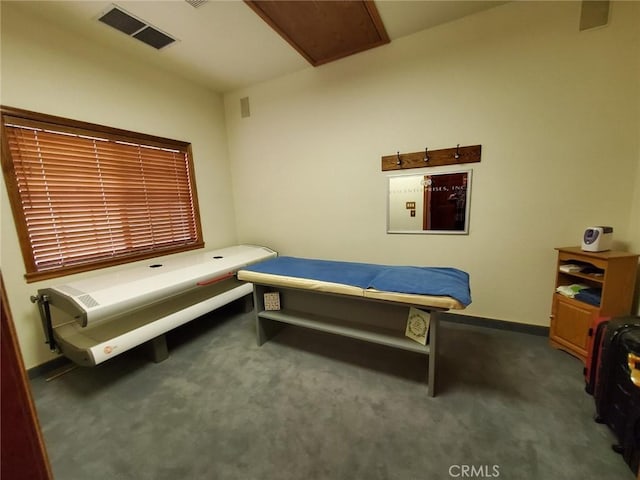 bedroom with dark colored carpet