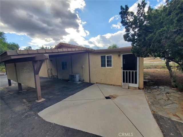 rear view of house with a patio and central air condition unit