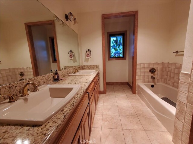 bathroom with tile patterned flooring, vanity, and a tub to relax in