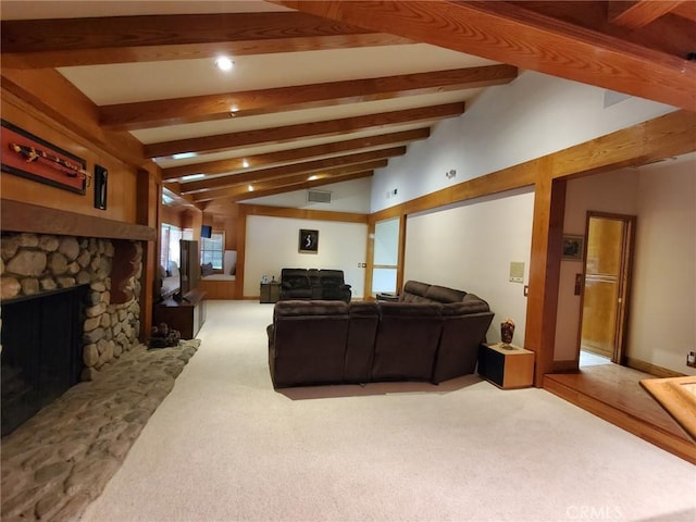 carpeted living room with a fireplace and lofted ceiling with beams