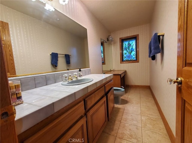 bathroom featuring tile patterned flooring, vanity, and toilet