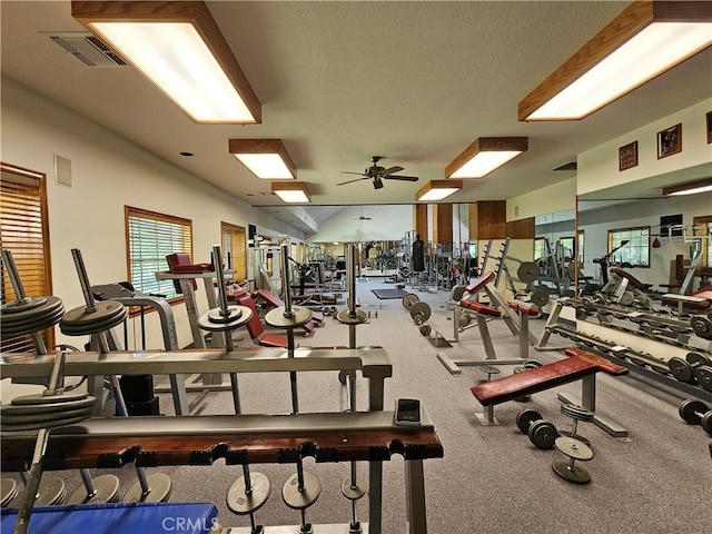 gym with a textured ceiling and ceiling fan