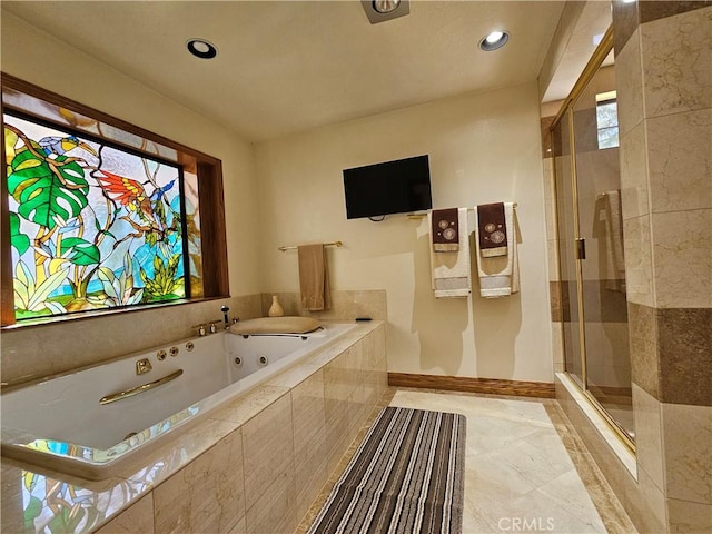 bathroom with plus walk in shower and a healthy amount of sunlight