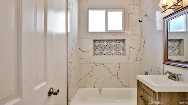 bathroom featuring shower / tub combination and vanity