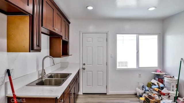 kitchen with light hardwood / wood-style floors and sink