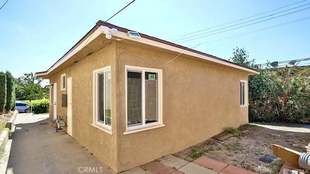 view of property exterior with a patio area