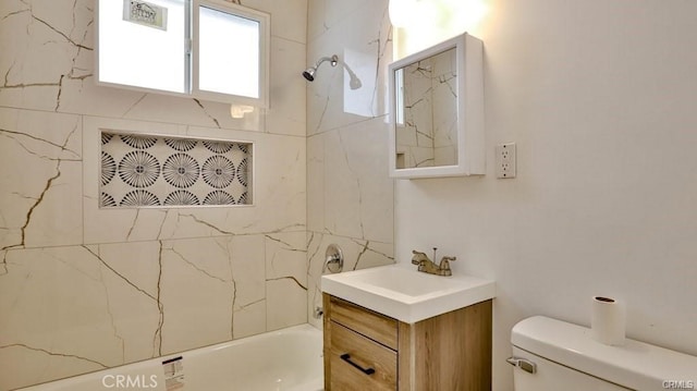 full bathroom with tiled shower / bath combo, vanity, and toilet