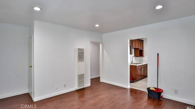 spare room featuring sink and hardwood / wood-style flooring