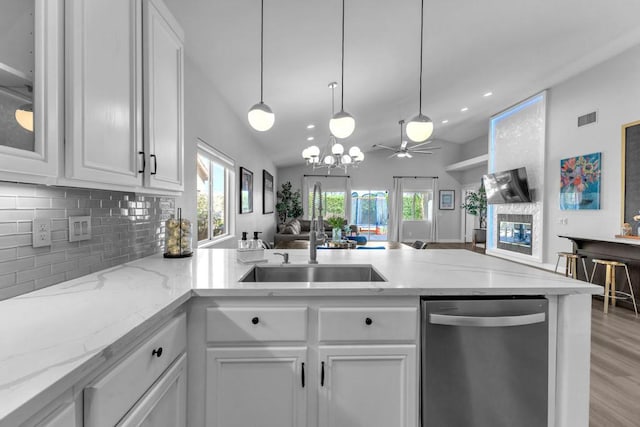 kitchen featuring dishwasher, ceiling fan with notable chandelier, sink, light hardwood / wood-style flooring, and white cabinetry