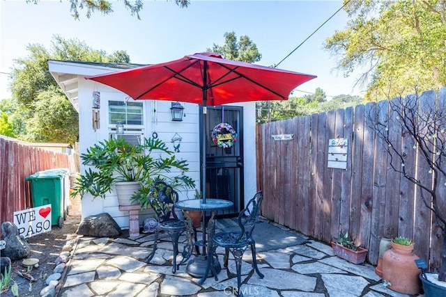 view of patio / terrace with cooling unit and fence