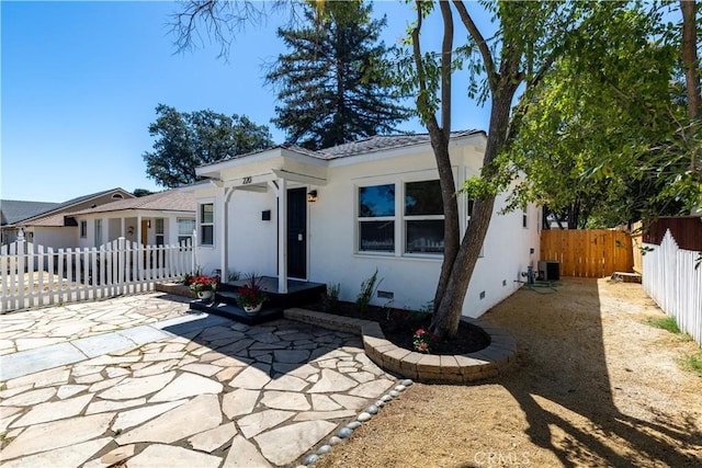 single story home with cooling unit and a patio area