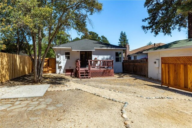 back of house with a deck