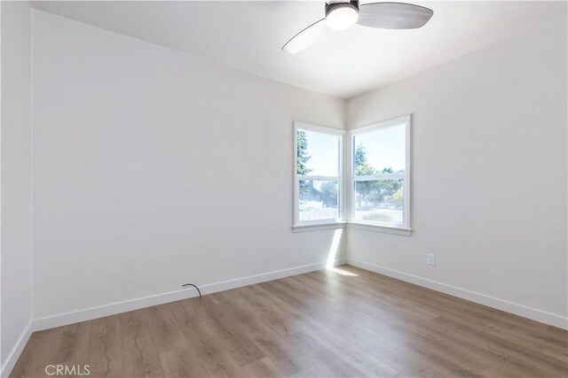 empty room with hardwood / wood-style flooring and ceiling fan