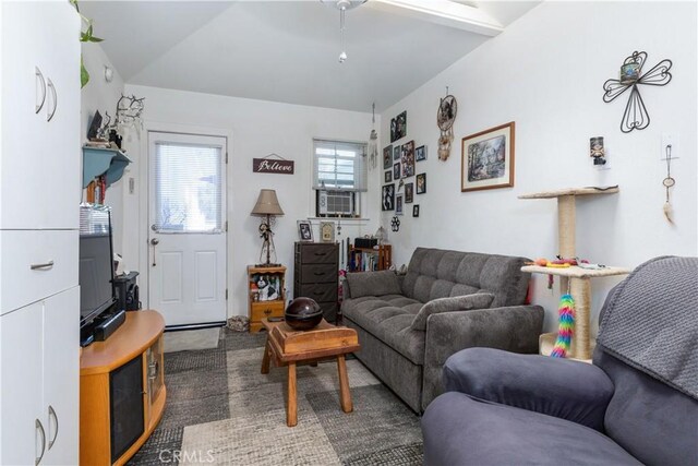 carpeted living room featuring vaulted ceiling