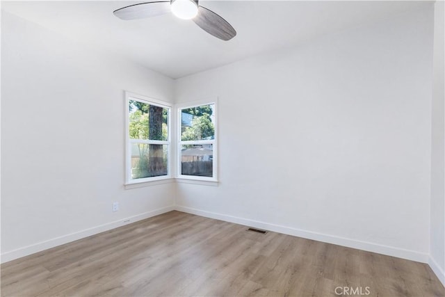 unfurnished room with ceiling fan and light wood-type flooring