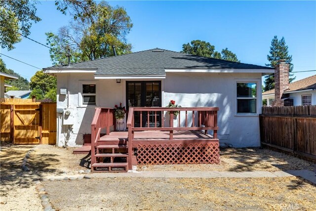 back of property featuring a wooden deck