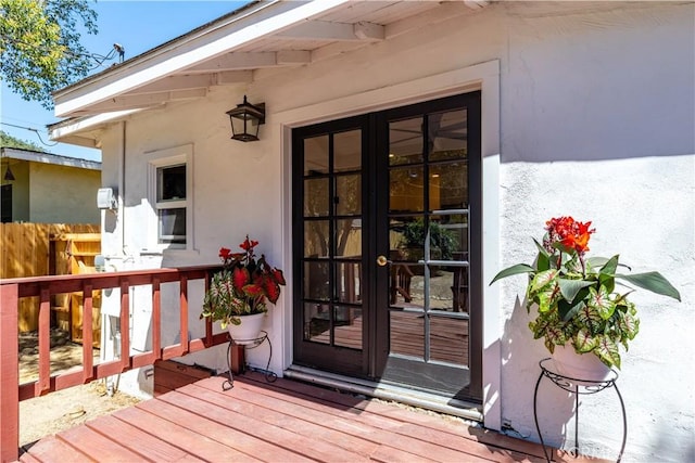 view of exterior entry featuring a deck