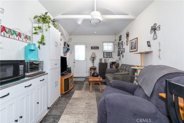 living room with lofted ceiling, cooling unit, and ceiling fan