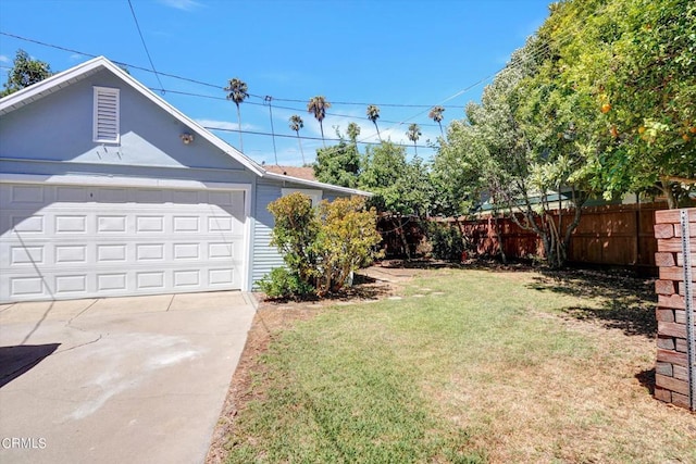 view of yard featuring driveway and fence