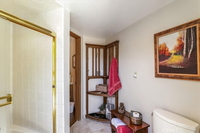 bathroom featuring toilet, tile patterned floors, and an enclosed shower