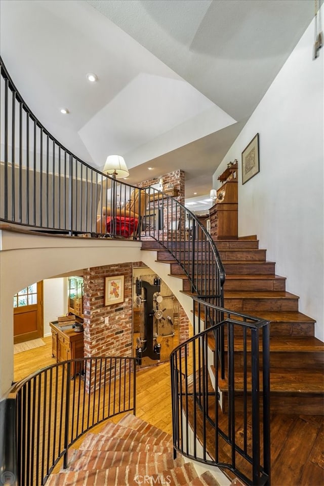 stairs featuring hardwood / wood-style floors