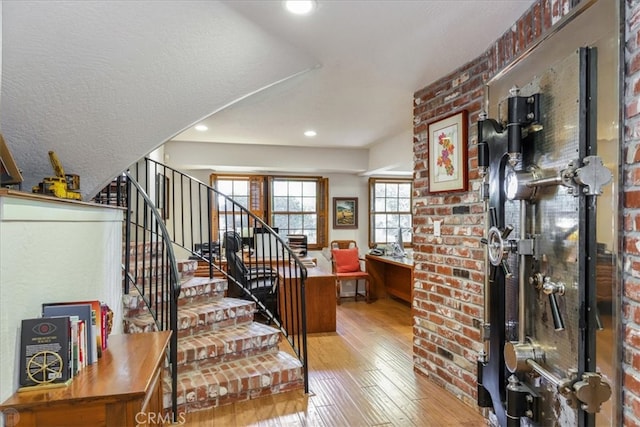 foyer with a textured ceiling and light hardwood / wood-style flooring