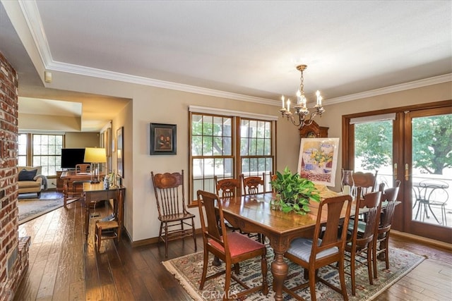 dining room with a notable chandelier, crown molding, and dark hardwood / wood-style flooring