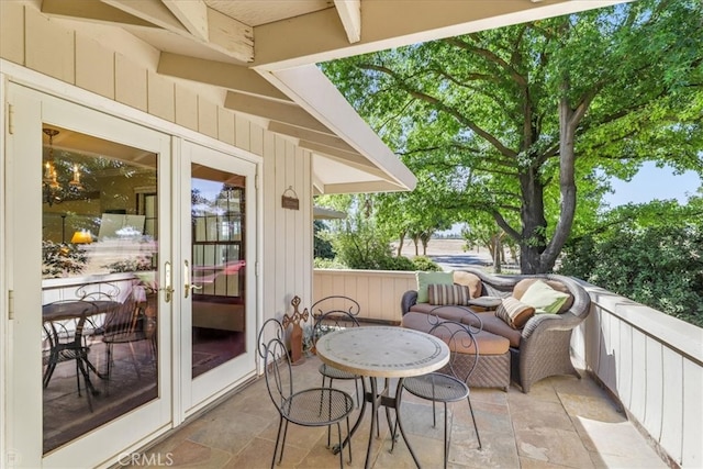 balcony featuring a patio and french doors