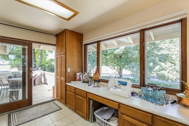 doorway featuring a healthy amount of sunlight and light tile patterned floors