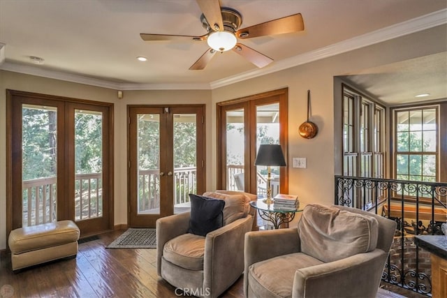 living area featuring ornamental molding, dark hardwood / wood-style floors, ceiling fan, and french doors