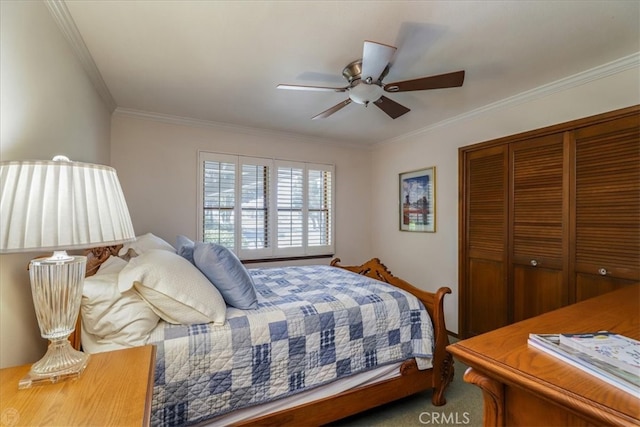 carpeted bedroom featuring crown molding, ceiling fan, and a closet