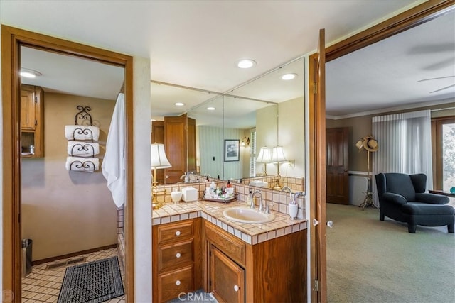 bathroom with ornamental molding, ceiling fan, and vanity