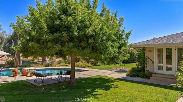 view of swimming pool with a yard and a patio area