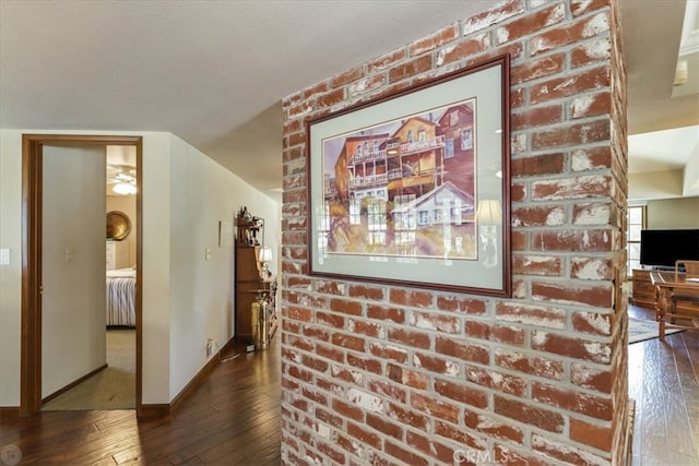 corridor featuring a textured ceiling and dark hardwood / wood-style floors