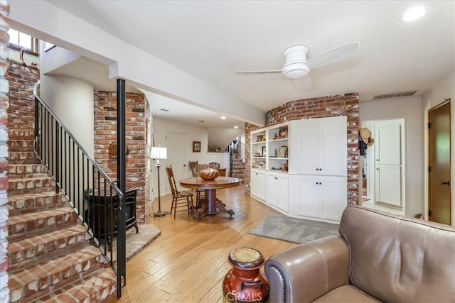 living room with light hardwood / wood-style floors and ceiling fan