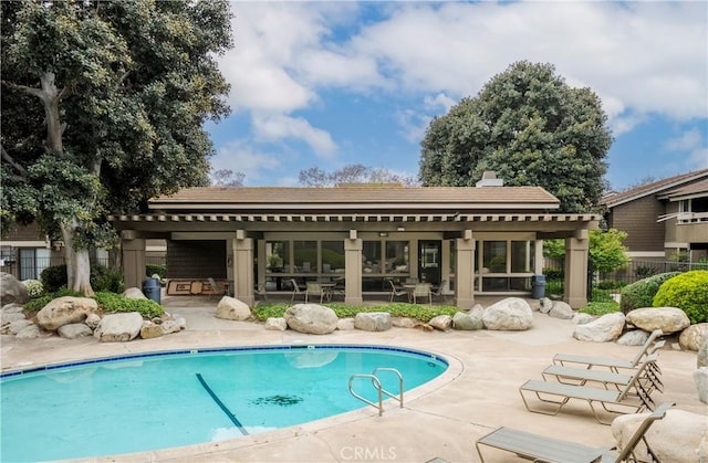 pool featuring a patio area and fence