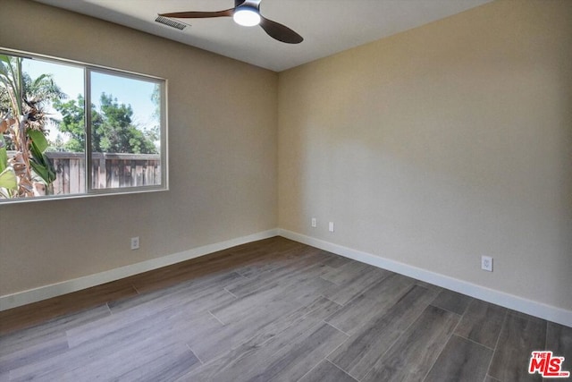 empty room featuring hardwood / wood-style floors and ceiling fan