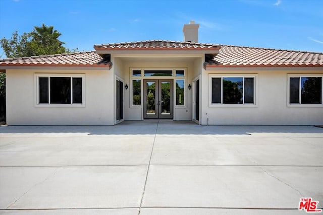 rear view of house featuring french doors and a patio area