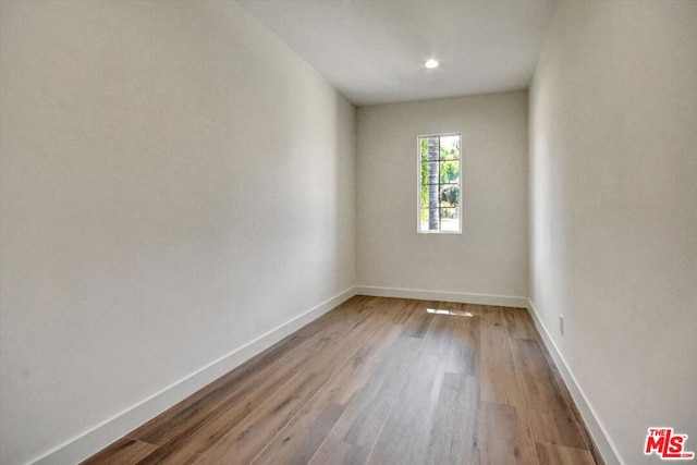 empty room with hardwood / wood-style flooring