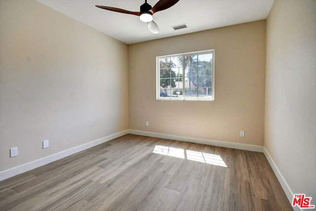 empty room with light wood-type flooring and ceiling fan