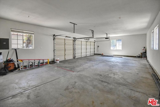 garage featuring a garage door opener and electric panel