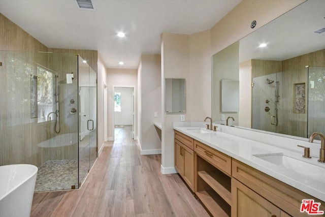 bathroom featuring vanity, plus walk in shower, and hardwood / wood-style flooring