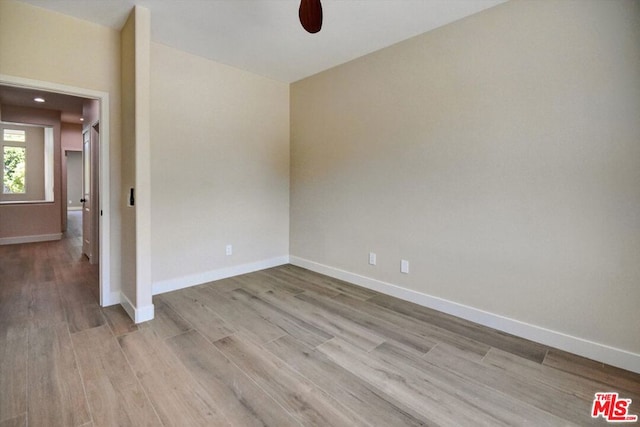 spare room featuring light hardwood / wood-style flooring and ceiling fan