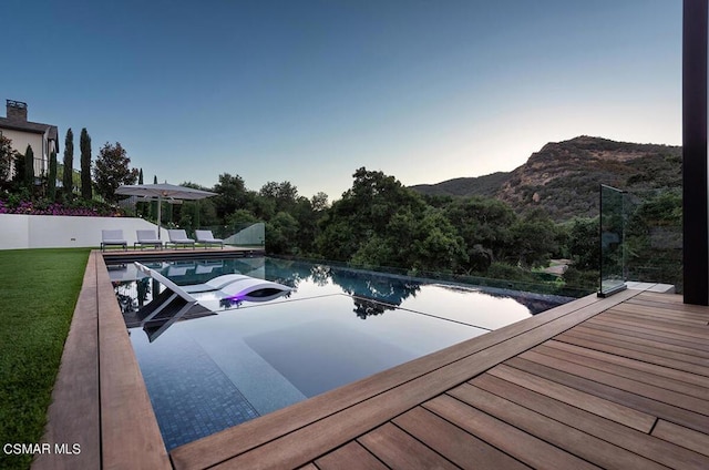 view of swimming pool with a mountain view