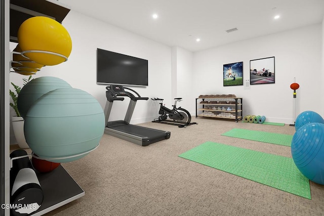 exercise area featuring carpet and golf simulator